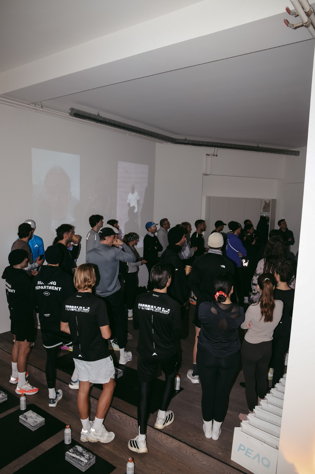 Crowd of runners gathered in Claw Studio after the Unsanctioned Streetrace with SANE, PEAQ bag in the foreground